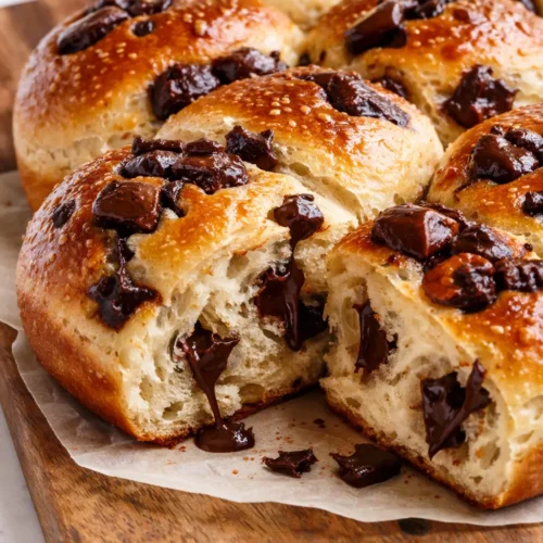 Golden brown chocolate chip milk buns, soft and pillowy, with melted chocolate chips, made using tangzhong for extra fluffiness.
