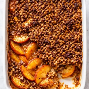 Baking shatteringly crispy peach crisp with brown butter topping, golden and crunchy texture.