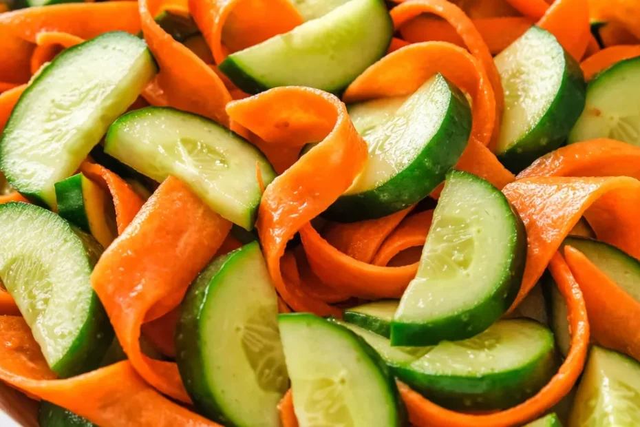 Crisp cucumber and carrot salad with tangy dressing, showcasing crunchy texture from salting step.