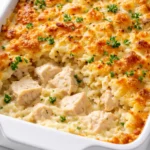 Golden brown Dolly Parton's easy 5-ingredient casserole in a baking dish, bubbly melted cheese and crispy edges.