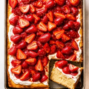 Toasting milk in a saucepan for strawberry shortcake sheet cake creates a golden, nutty base with a creamy texture.
