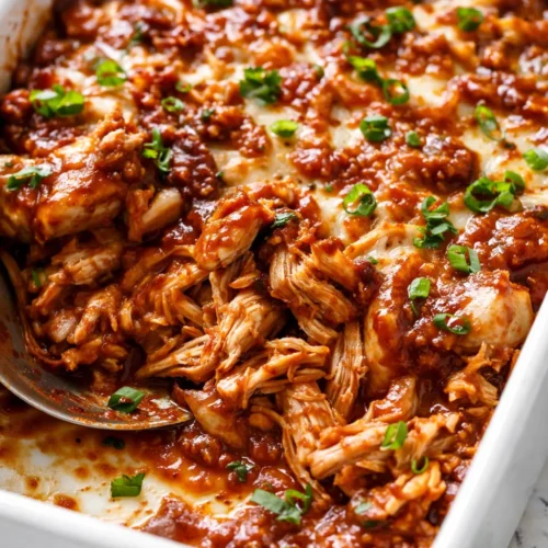 Creamy BBQ ranch chicken casserole with melted cheese and smoky browned edges, served in a baking dish.