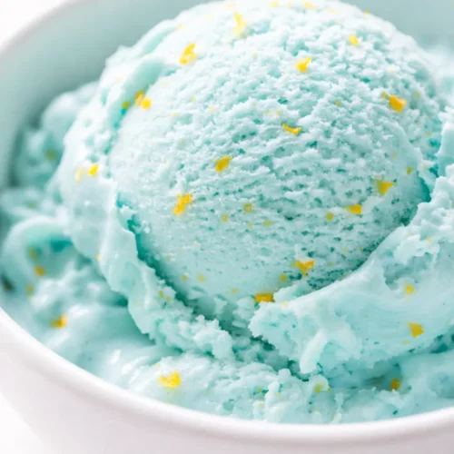 Vibrant blue scoop of creamy ice cream in a bowl, capturing the authentic flavor of the Midwest original blue moon ice cream recipe.