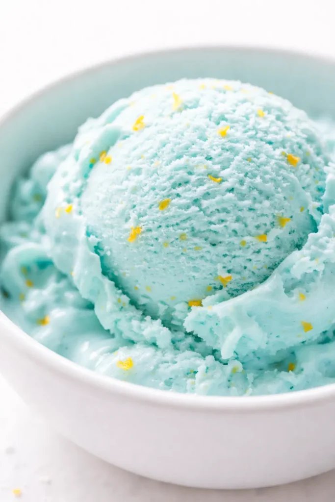 Vibrant blue scoop of creamy ice cream in a bowl, capturing the authentic flavor of the Midwest original blue moon ice cream recipe.