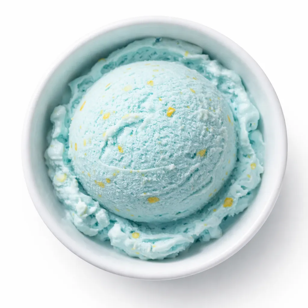 Vibrant blue ice cream base churning in a mixer with creamy texture and specks of vanilla bean