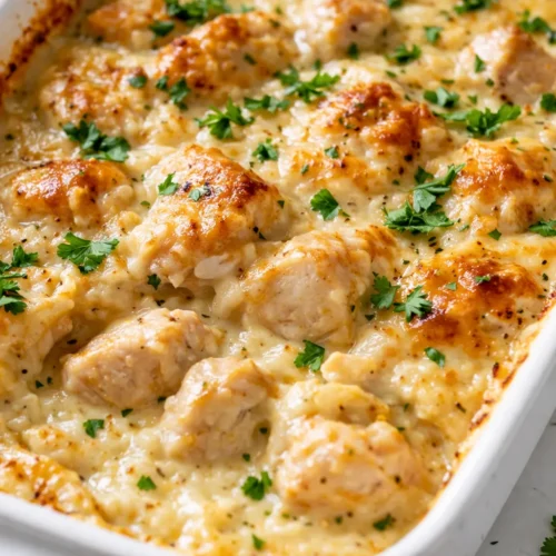 Golden brown creamy low carb chicken casserole with tender chicken pieces and melted cheese topping.