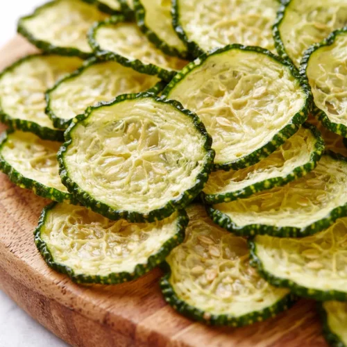 Crispy crunchy ranch cucumber chips, oven-baked to golden brown, with a light ranch coating and vibrant green cucumber centers.