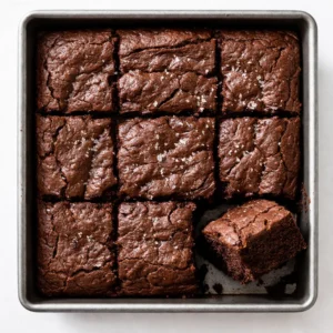 Rich fudgy chocolate cake batter in a single bowl, glossy dark texture indicating intense cocoa flavor.