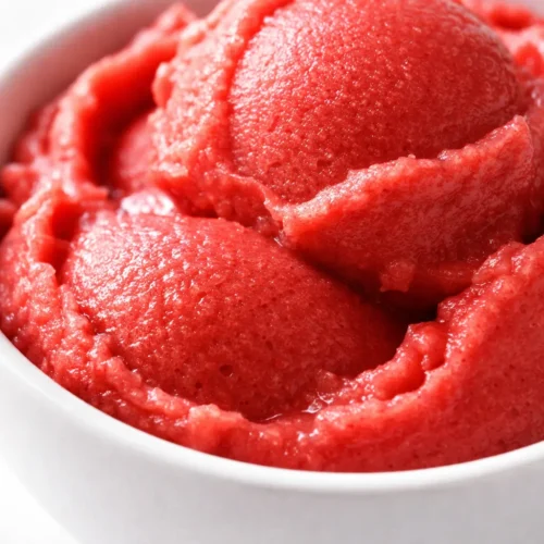 Vibrant Ninja Creami sorbet scoop with fresh fruit chunks, smooth texture and bright colors.