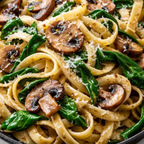 Creamy one-skillet parmesan spinach mushroom pasta with tender mushrooms and wilted spinach, ready in 20 minutes.