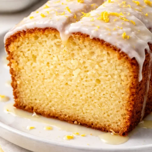 Moist Starbucks copycat lemon loaf with syrup soak, golden crumb, and white glaze drizzled on top