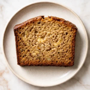 Cold butter cut into flour mixture for velvet banana bread, ensuring moist texture.