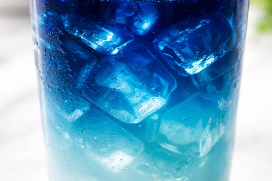 A vibrant ocean latte with a stunning natural gradient of blue, teal, and white, topped with a creamy foam.