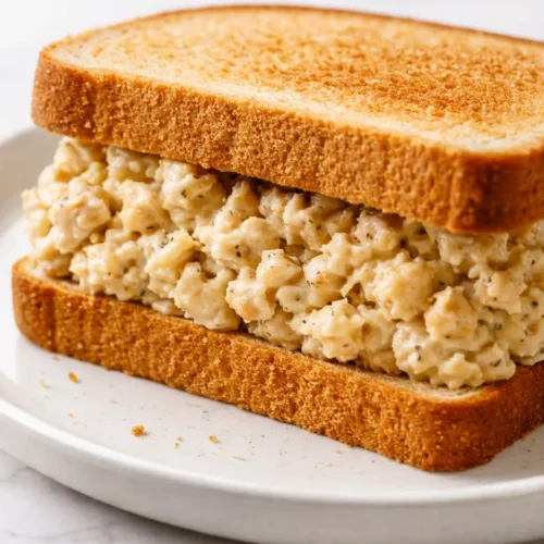 Hearty chickpea salad sandwich on whole wheat bread with crunchy veggies and creamy, non-soggy filling.